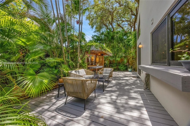 2427 Tequesta Ln, Miami, FL 33133 - wooden deck featuring an outdoor living space