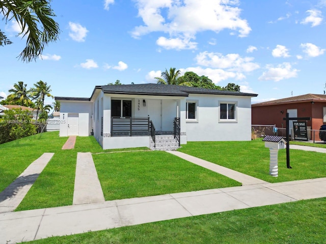 3455 E 1st Ct, Hialeah, FL 33013 - view of front facade featuring covered porch and stucco siding