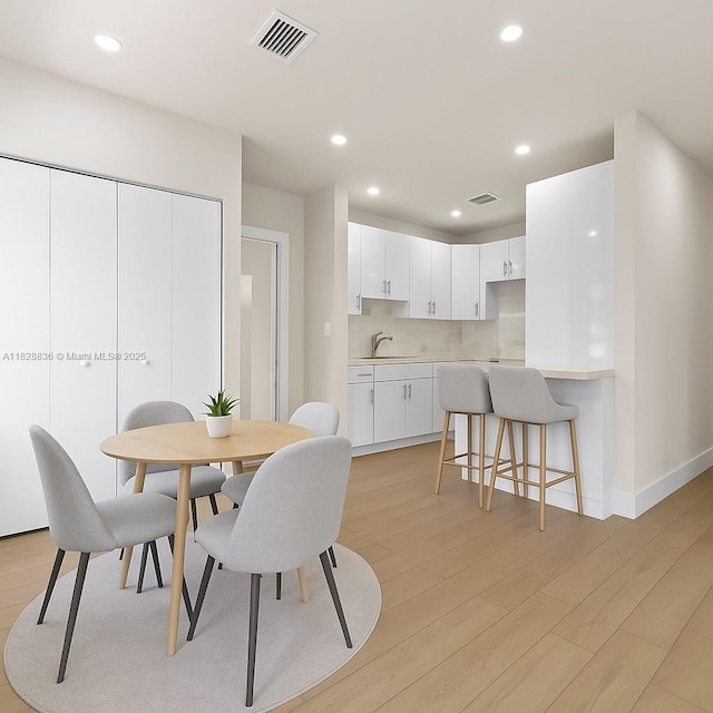 3455 E 1st Ct, Hialeah, FL 33013 - dining area featuring light wood-style flooring and recessed lighting