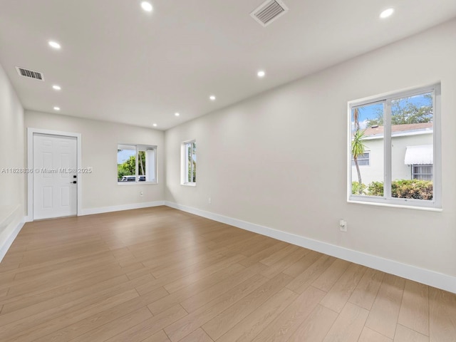 3455 E 1st Ct, Hialeah, FL 33013 - empty room featuring healthy amount of natural light, light wood finished floors, and recessed lighting