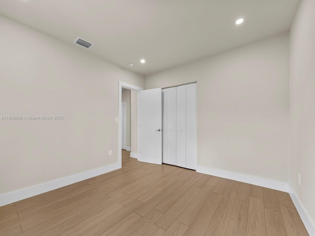 3455 E 1st Ct, Hialeah, FL 33013 - unfurnished bedroom featuring light wood-style floors, recessed lighting, and a closet