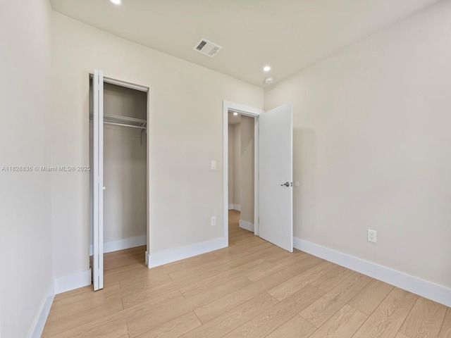 3455 E 1st Ct, Hialeah, FL 33013 - unfurnished bedroom featuring light wood finished floors, recessed lighting, and a closet