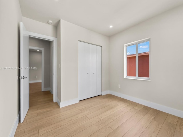 3455 E 1st Ct, Hialeah, FL 33013 - unfurnished bedroom with light wood-style floors, a closet, and recessed lighting
