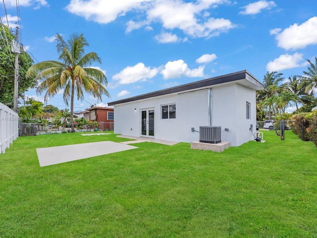 3455 E 1st Ct, Hialeah, FL 33013 - back of property with french doors, a fenced backyard, stucco siding, and a patio