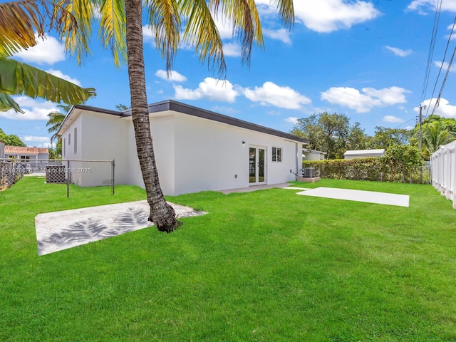 3455 E 1st Ct, Hialeah, FL 33013 - back of house featuring french doors, stucco siding, a patio, and a fenced backyard