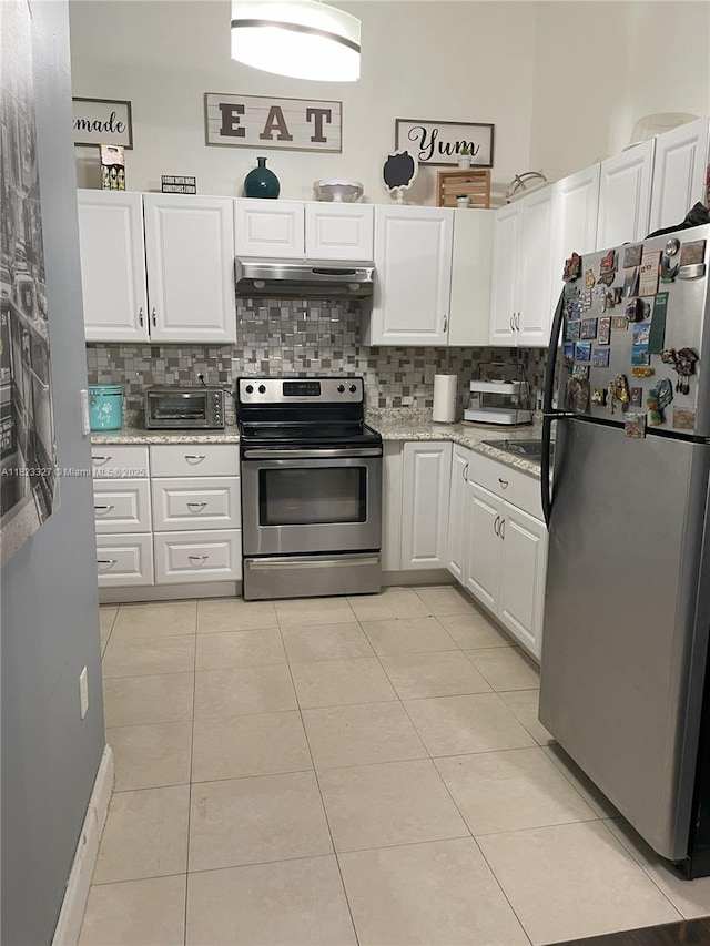 7525 SW 153rd Pl Unit 203-11, Miami, FL 33193 - kitchen with stainless steel appliances, under cabinet range hood, white cabinets, decorative backsplash, and light tile patterned flooring