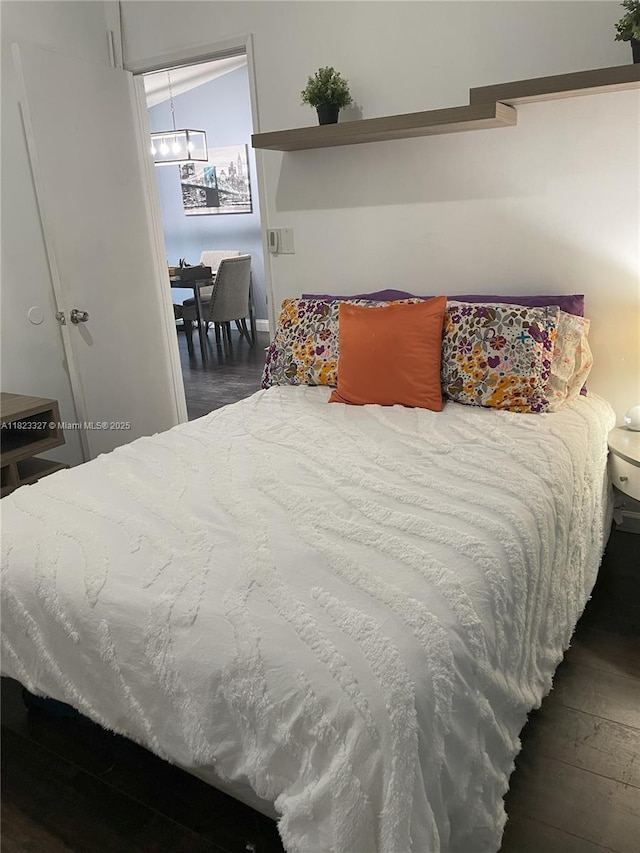 7525 SW 153rd Pl Unit 203-11, Miami, FL 33193 - bedroom with dark wood-style flooring and a chandelier