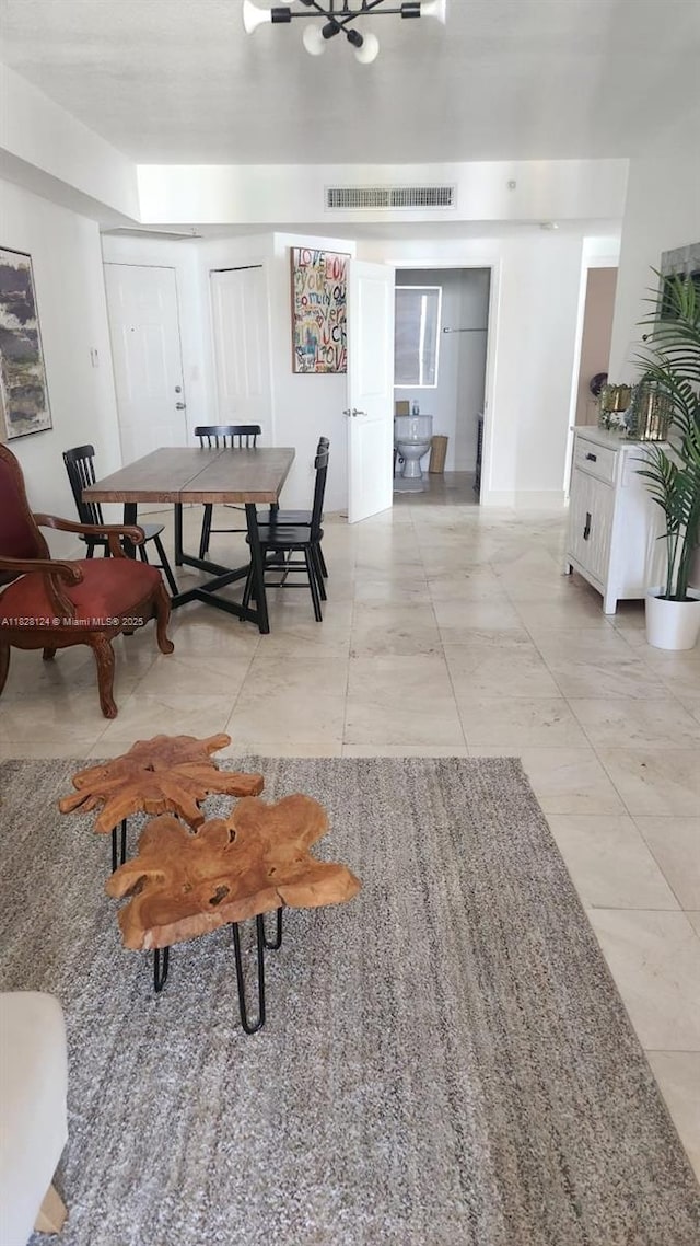 170 SE 14th St Unit 2405, Miami, FL 33131 - dining space with a chandelier and light tile patterned floors