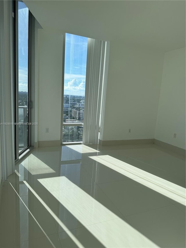 1010 SW 2nd Ave Unit Ph06, Miami, FL 33130 - unfurnished room with healthy amount of natural light and tile patterned floors