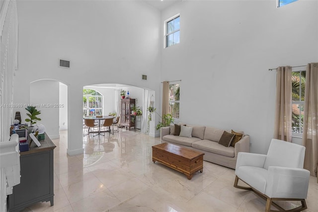 2620 SW 150th Ct, Miami, FL 33185 - living room with arched walkways, a high ceiling, and light marble finish flooring