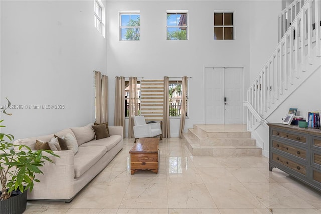 2620 SW 150th Ct, Miami, FL 33185 - living area with marble tiled floors, a high ceiling, and stairs