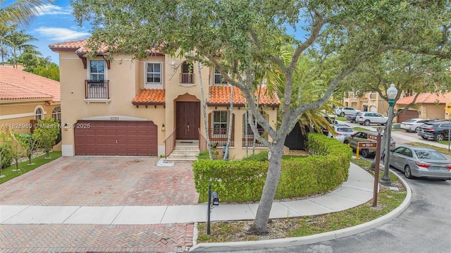 2620 SW 150th Ct, Miami, FL 33185 - view of front of property featuring a tile roof, a garage, stucco siding, and decorative driveway
