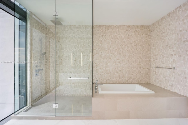 88 SW 7th St Unit 4101, Miami, FL 33130 - full bathroom featuring a shower stall, a bath, and tile walls