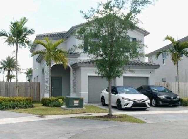 1433 SE 27th Ter, Homestead, FL 33035 - mediterranean / spanish house with driveway, a garage, stucco siding, and a tiled roof