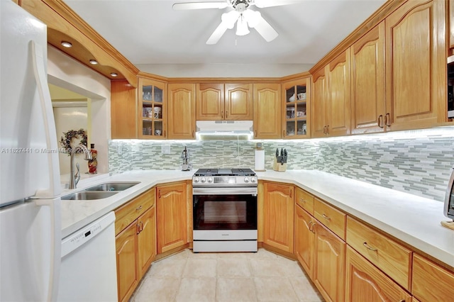 16702 NW 73rd Ct, Hialeah, FL 33015 - kitchen with white appliances, under cabinet range hood, light countertops, and decorative backsplash
