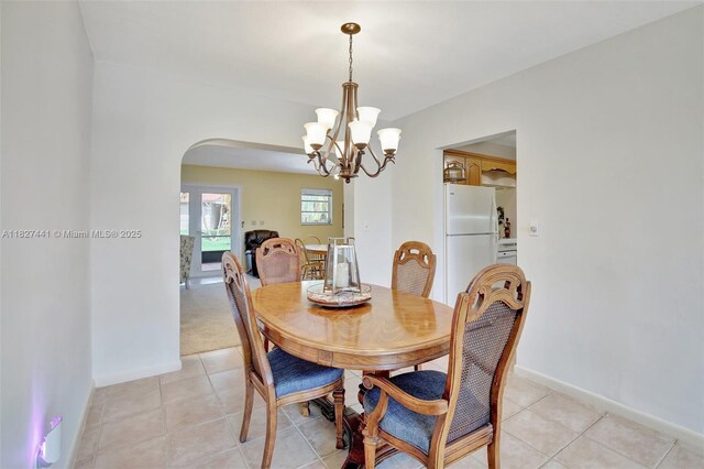 16702 NW 73rd Ct, Hialeah, FL 33015 - dining room featuring arched walkways, a chandelier, and light tile patterned floors