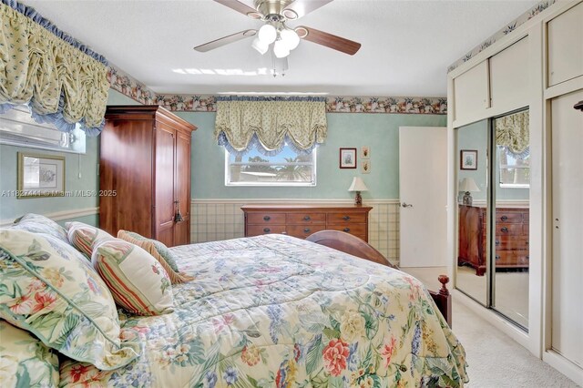 16702 NW 73rd Ct, Hialeah, FL 33015 - bedroom with multiple windows, light colored carpet, wainscoting, a ceiling fan, and a closet