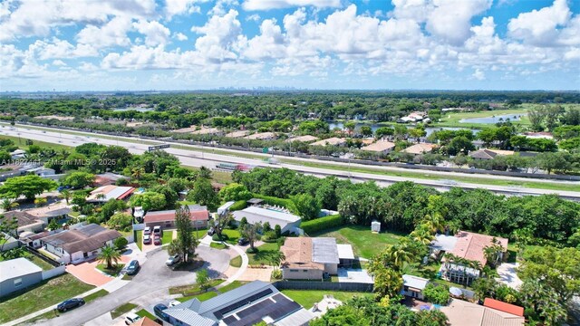 16702 NW 73rd Ct, Hialeah, FL 33015 - aerial perspective of suburban area featuring a nearby body of water and a tree filled landscape