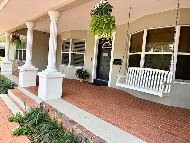 1330 Harrison St, Hollywood, FL 33019 - property entrance featuring covered porch and stucco siding