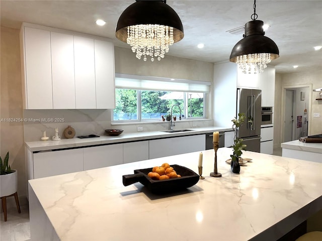 1330 Harrison St, Hollywood, FL 33019 - kitchen featuring a chandelier, appliances with stainless steel finishes, modern cabinets, white cabinetry, and recessed lighting
