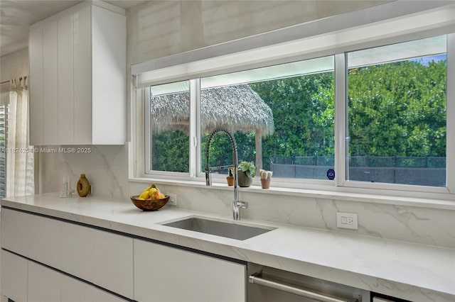 1330 Harrison St, Hollywood, FL 33019 - kitchen featuring white cabinets, dishwashing machine, healthy amount of natural light, and tasteful backsplash