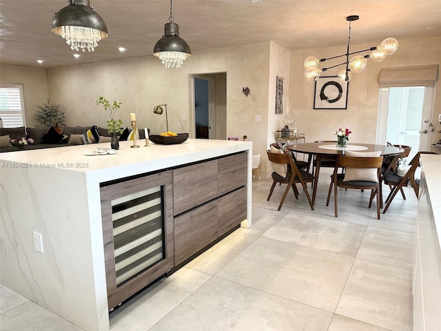 1330 Harrison St, Hollywood, FL 33019 - kitchen with beverage cooler, hanging light fixtures, light countertops, a chandelier, and modern cabinets