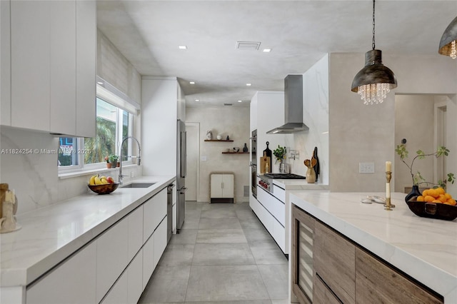 1330 Harrison St, Hollywood, FL 33019 - kitchen with wall chimney exhaust hood, modern cabinets, white cabinets, light stone counters, and recessed lighting