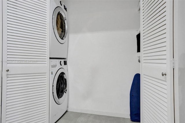 1330 Harrison St, Hollywood, FL 33019 - laundry area with stacked washing machine and dryer and light tile patterned flooring