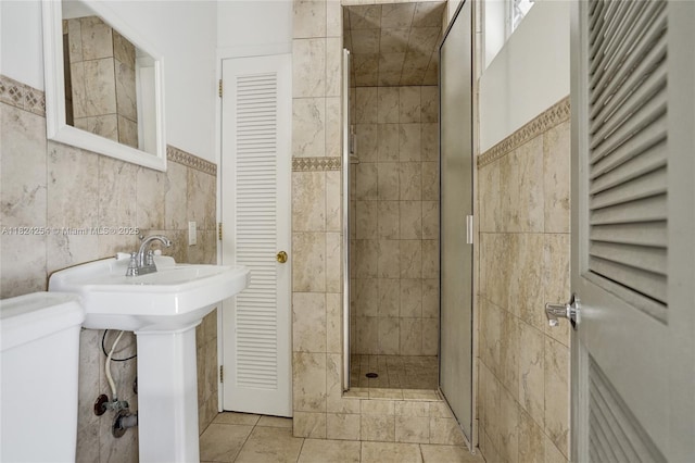 1330 Harrison St, Hollywood, FL 33019 - bathroom featuring a stall shower, tile walls, a closet, and tile patterned flooring