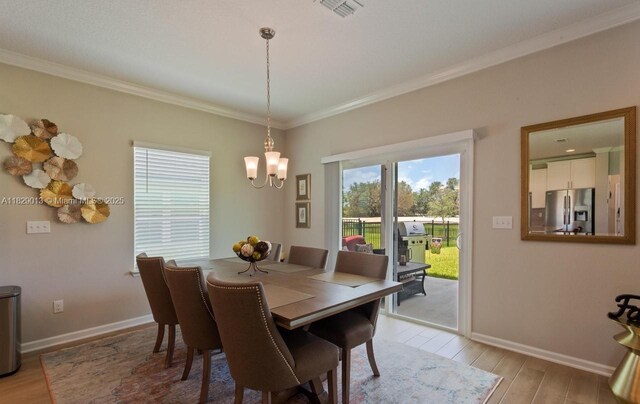 365 Cedarstone Way, Saint Augustine, FL 32092 - dining room with a chandelier, light wood-style floors, and ornamental molding