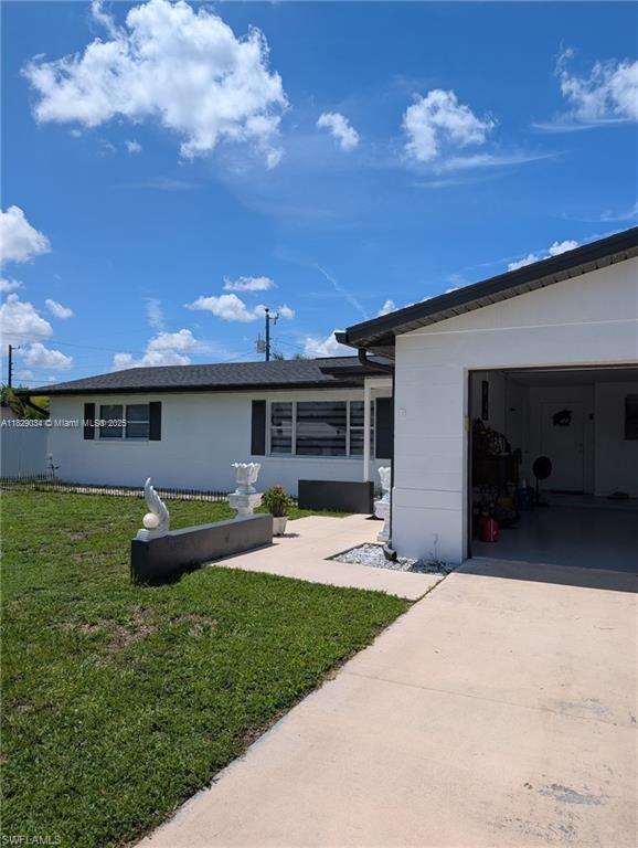1206 Archdale St, Lehigh Acres, FL 33936 - ranch-style house featuring concrete driveway and an attached garage