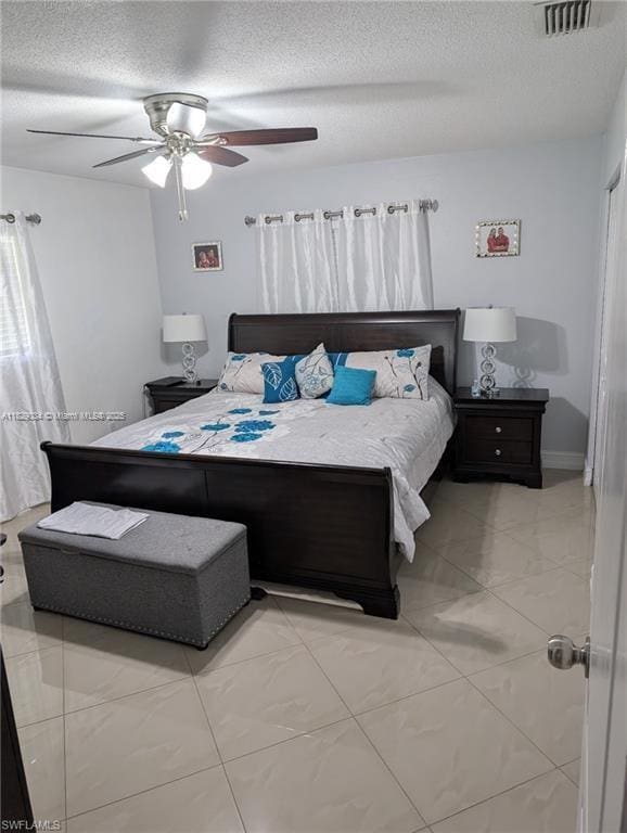 1206 Archdale St, Lehigh Acres, FL 33936 - bedroom featuring a textured ceiling and a ceiling fan