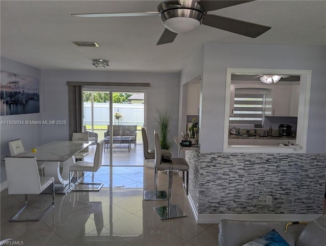 1206 Archdale St, Lehigh Acres, FL 33936 - dining area with ceiling fan and light tile patterned flooring