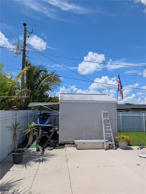 1206 Archdale St, Lehigh Acres, FL 33936 - garage with a storage shed