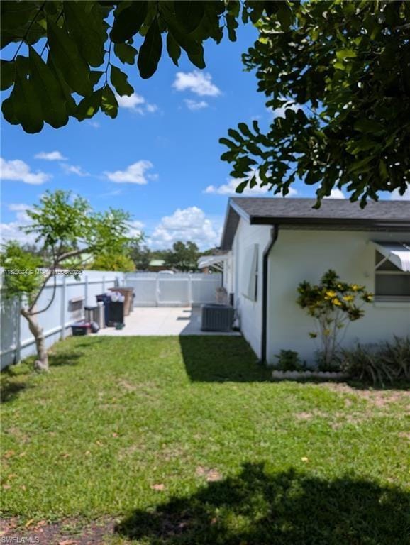 1206 Archdale St, Lehigh Acres, FL 33936 - fenced backyard with a patio area
