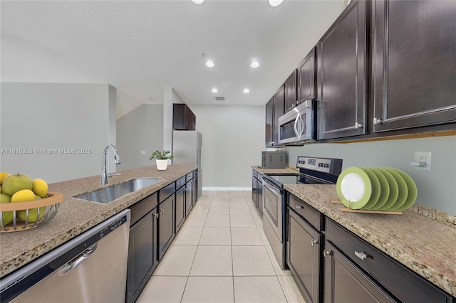 14776 SW 10th St Unit 10501, Pembroke Pines, FL 33027 - kitchen featuring stainless steel appliances, light stone countertops, recessed lighting, dark brown cabinets, and light tile patterned floors