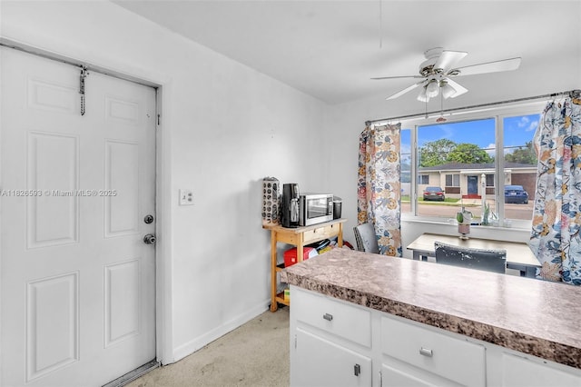412 S 24th Ave, Hollywood, FL 33020 - kitchen featuring white cabinetry, a ceiling fan, stainless steel microwave, and concrete floors