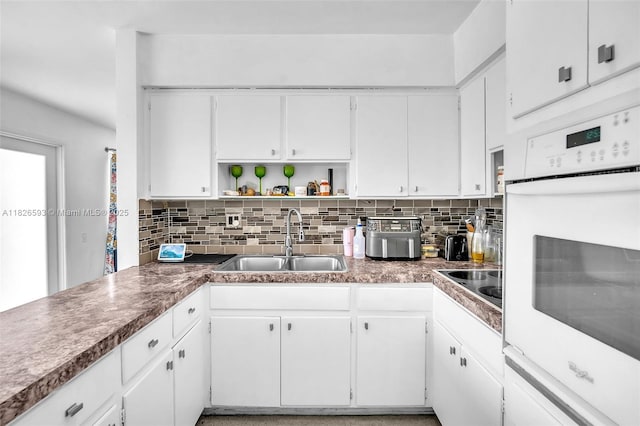 412 S 24th Ave, Hollywood, FL 33020 - kitchen featuring white oven, open shelves, tasteful backsplash, and white cabinetry