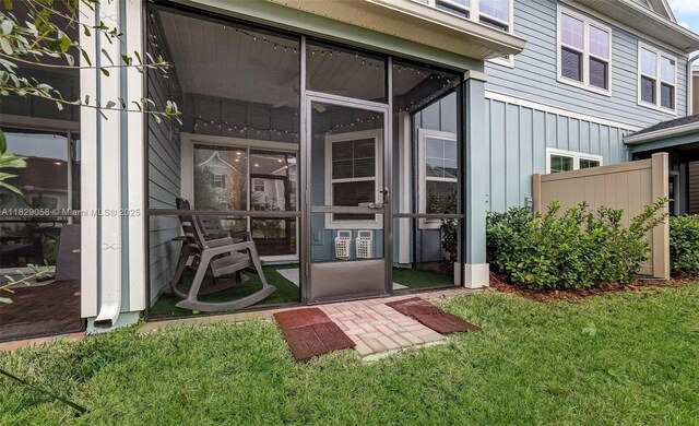 42 Appleton Ct, Saint Augustine, FL 32092 - view of exterior entry with a yard and board and batten siding