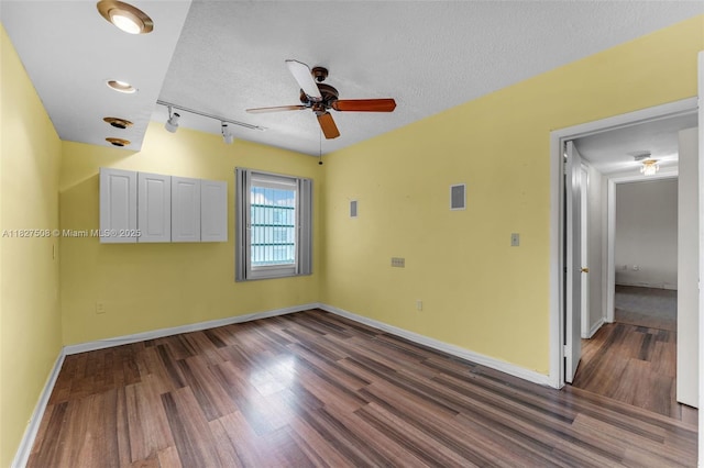 9159 SW 77th Ave Unit 314, Miami, FL 33156 - empty room featuring wood finished floors, ceiling fan, a textured ceiling, and rail lighting