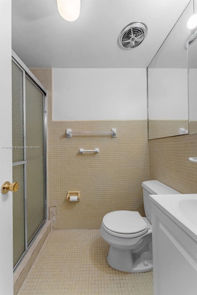 9159 SW 77th Ave Unit 314, Miami, FL 33156 - bathroom featuring a stall shower, tile walls, vanity, and tile patterned flooring