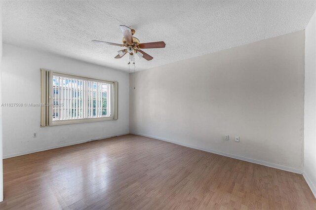 9159 SW 77th Ave Unit 314, Miami, FL 33156 - spare room featuring wood finished floors, a ceiling fan, and a textured ceiling