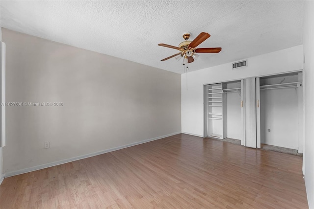 9159 SW 77th Ave Unit 314, Miami, FL 33156 - unfurnished bedroom featuring wood finished floors, a textured ceiling, a closet, and a ceiling fan
