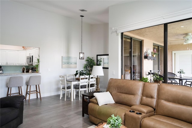 10631 NW 14th St Unit 212, Plantation, FL 33322 - living area featuring wood finished floors, ceiling fan, and a high ceiling