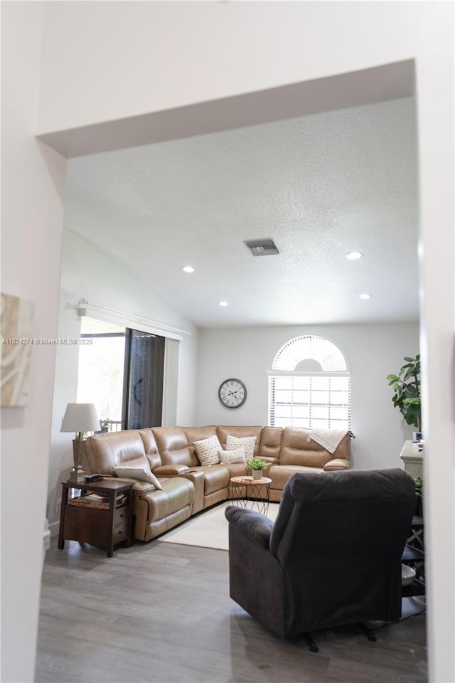 10631 NW 14th St Unit 212, Plantation, FL 33322 - living area featuring plenty of natural light, wood finished floors, and recessed lighting