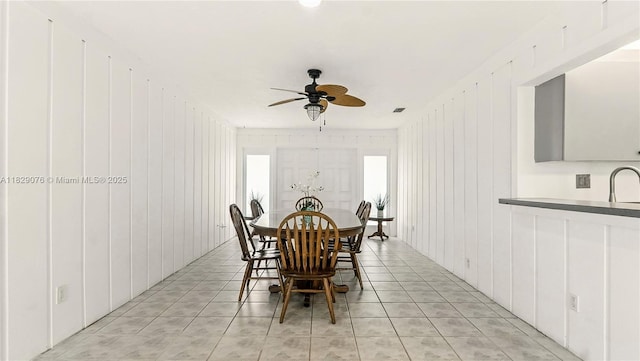 1482 SE Manth Ln, Port St Lucie, FL 34983 - dining room with a ceiling fan and light tile patterned floors