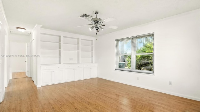1482 SE Manth Ln, Port St Lucie, FL 34983 - spare room featuring a ceiling fan, light wood-style floors, built in features, and ornamental molding