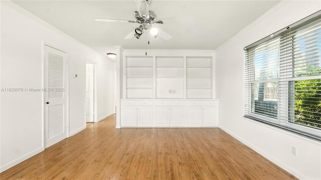 1482 SE Manth Ln, Port St Lucie, FL 34983 - unfurnished dining area with a ceiling fan, light wood finished floors, and ornamental molding