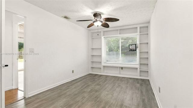 1482 SE Manth Ln, Port St Lucie, FL 34983 - spare room with a ceiling fan, wood finished floors, and a textured ceiling