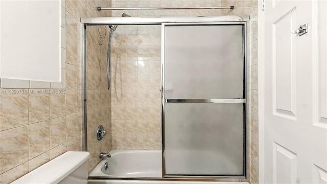 1482 SE Manth Ln, Port St Lucie, FL 34983 - bathroom with toilet and shower / bath combination with glass door